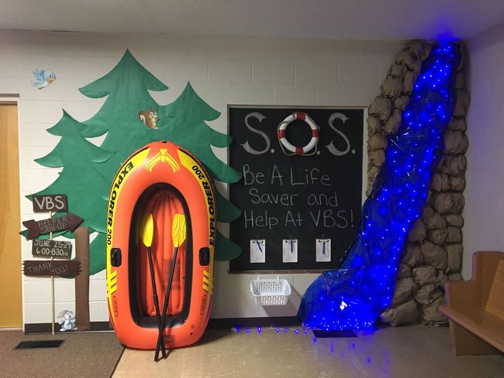 an inflatable life jacket is next to a sign that says sos be a life saver and help at vbs