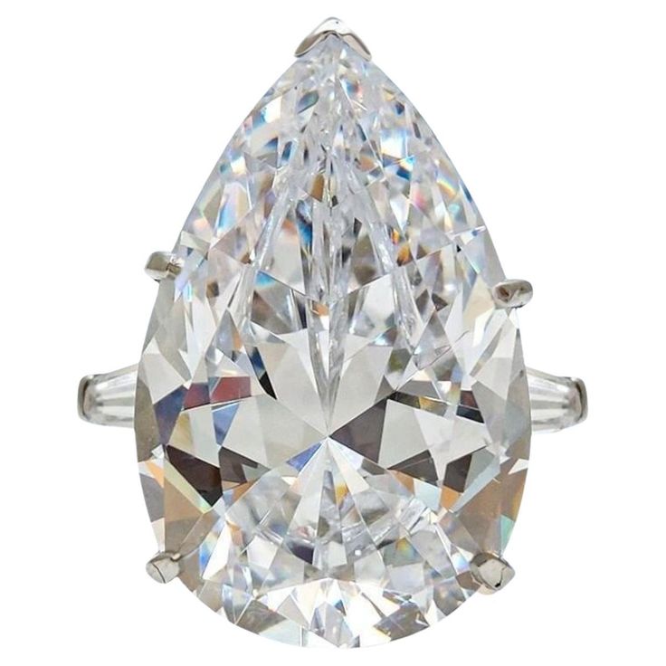 a pear shaped diamond ring on a white background