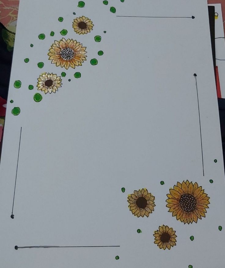 the paper has sunflowers painted on it and is next to some green dots