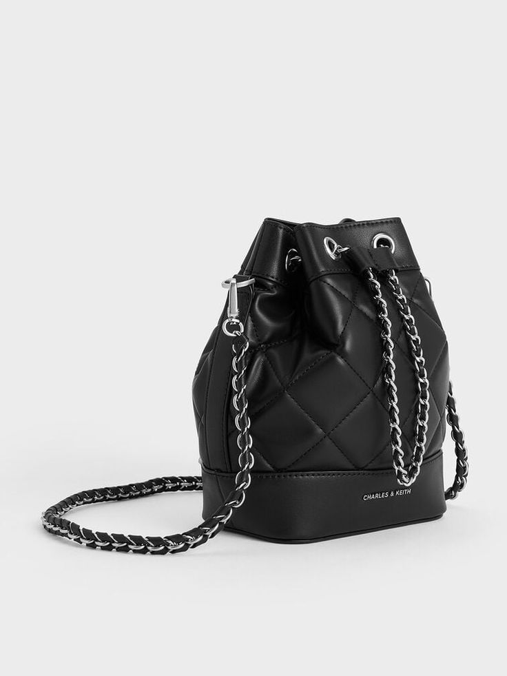 This product is made with at least 20% sustainable materials by weight. CHARLES & KEITH uses recycled, degradable, organic, and water-based materials in our eco-conscious collection. The classic bucket bag silhouette meets a timeless quilted finish in this elegant piece. With a simple change of straps, it effortlessly transforms into a backpack, yielding a plethora of styling options. This innovative feature not only eases the load on your shoulder but also ensures you can navigate your day-to-day activities with ease and comfort. Black Saddle Bag, Charles And Keith, Bag Silhouette, Chic Crossbody Bag, Classic Handbags, Wallet Gifts, Charles Keith, Eco Conscious, Sustainable Materials