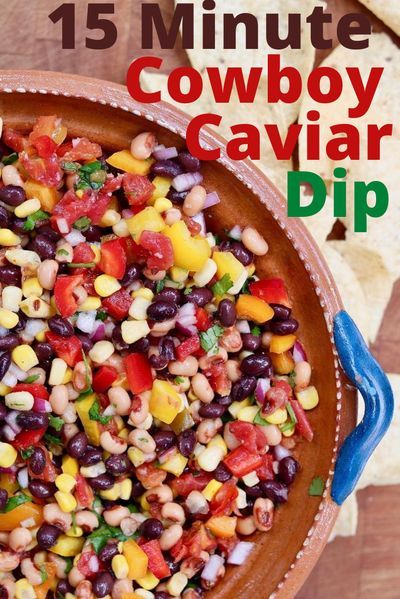 a bowl filled with beans and corn next to tortilla chips