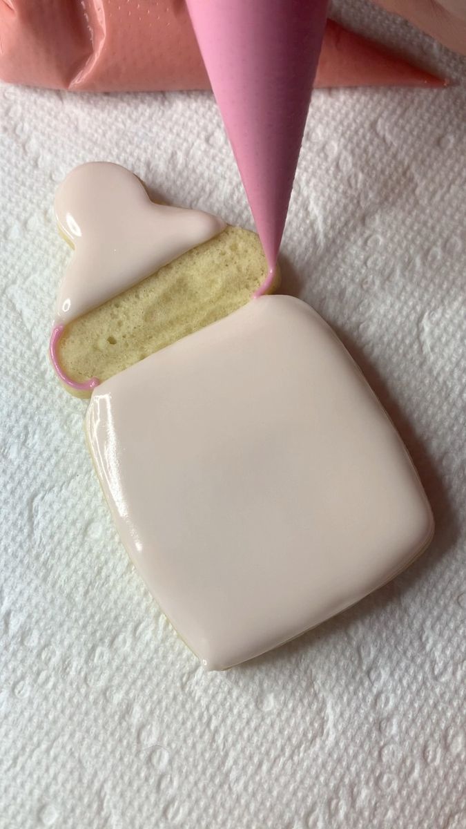 a piece of cake sitting on top of a white plate next to a pink cone