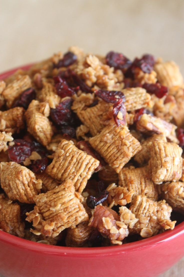 a red bowl filled with cereal and raisins