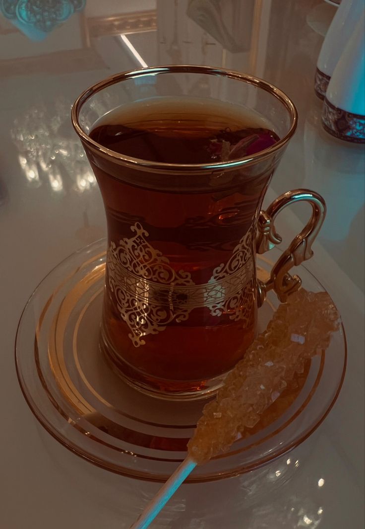 a glass cup filled with liquid sitting on top of a plate