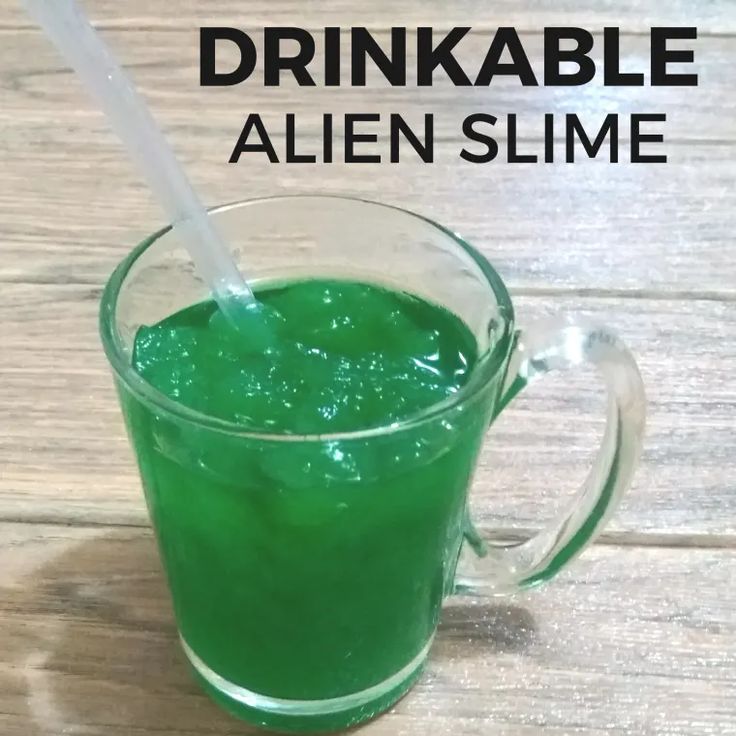 a green drink in a glass with a straw sticking out of it and text overlay that reads, drinkable alien slime