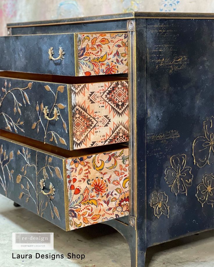 an ornate painted chest of drawers on wheels