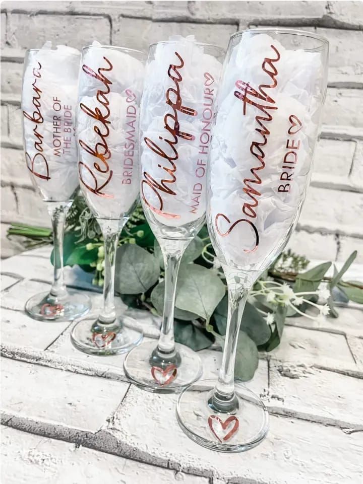 three wine glasses with the words happy mother on them sitting next to some greenery