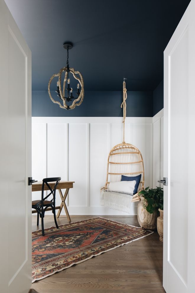 a room with blue walls and white paneling