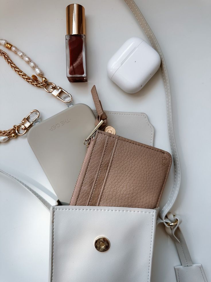 Artfully organize your belongings with THE CÆP's Mate Mini Crossbody. We believe the Mini Mate is the perfect accessory for basically any activity! Crafted with vegan leather, this chic accessory features an adjustable strap (19" min. drop, 23" max. drop), a main compartment that fits all phones with slim cases plus other essentials, an interior back pocket for cards and receipts. Plus, it has a ring for extra clip-on options, magnetic closure, and light gold hardware. Measurements of the Bag: W Trendy Rectangular Case Bag With Card Slots, Trendy Brown Everyday Wallets, Trendy Brown Wallet For Everyday Use, Trendy Phone Bag With Removable Pouch, Trendy Leather Bag With Card Slots, Trendy Brown Wallets For Everyday Use, Beige Crossbody Bag With Card Slots, Beige Pouch Bag With Card Slots, Trendy Wallets With Interior Card Slots