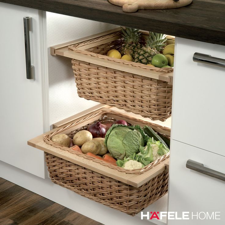 two wicker baskets with vegetables in them are sitting on the shelf next to an oven