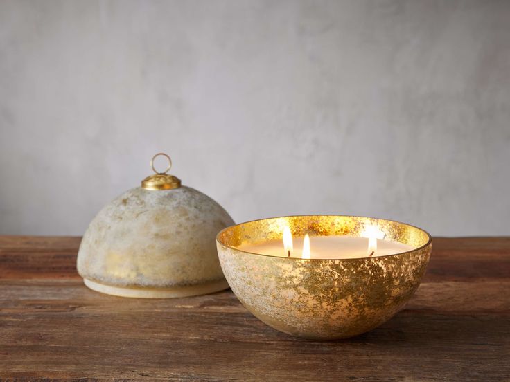 a candle is lit in front of a bowl