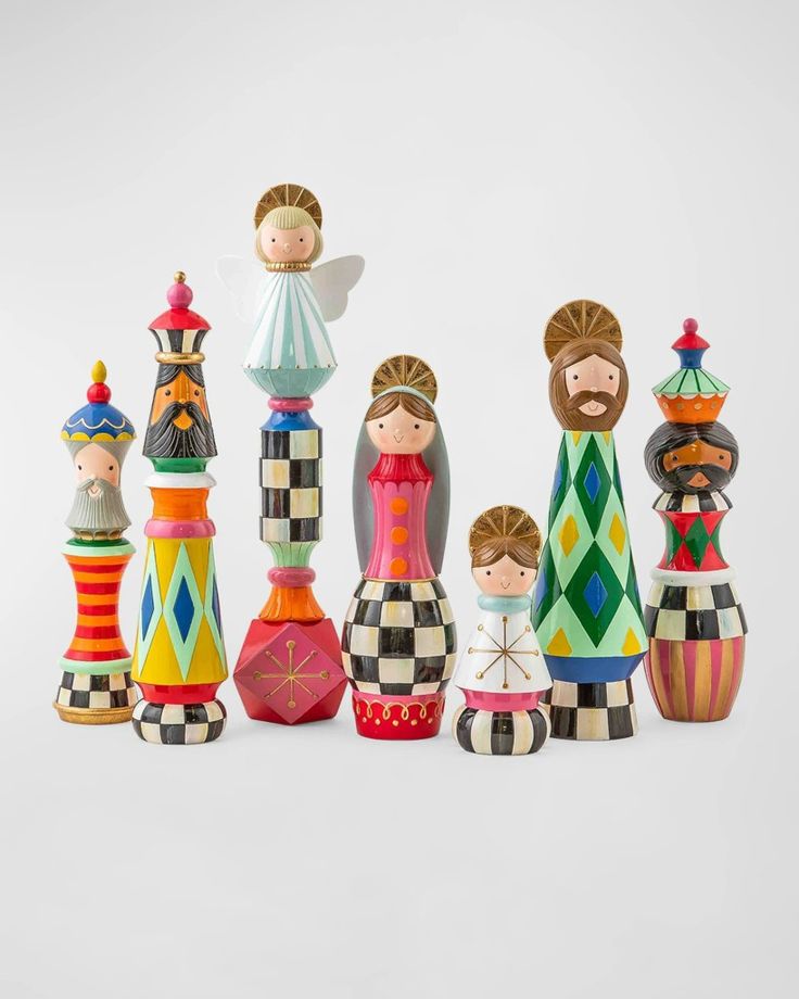 an assortment of colorful ceramic figurines sitting on top of each other