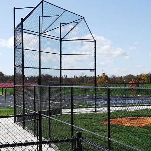 the baseball field is fenced off and ready to be used as a batting cage