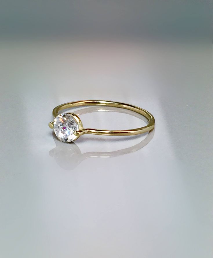 Simple and unique Floating Stone Ring. This ring is Extremely cute and Dainty also for stacking, thumb or midi and a great addition for your collection or as a perfect gift. --Great for Baby/kids as birthstone Rings. --14k/10k Real Solid Gold --Band Thickness: 1.0mm --CZ approx : 3mm wide = 0.10 ctw --Diamond Option: Natural .10 ct Si quality ** Limited time SALE ** Order Yours Today Please message me for larger size! SALE!! Great Value! **Dainty Rings On SALE Now** **100% Quality Guaranteed** - Simple Design Crystal Ring For Anniversary, Elegant Everyday Crystal Ring With Round Band, Classic Everyday Open Birthstone Ring, Everyday Classic Crystal Ring, Classic Crystal Ring With Round Band For Everyday, Classic Everyday Crystal Ring With Round Band, Everyday Classic Crystal Ring With Round Band, Classic Open Crystal Ring For Everyday, Classic Everyday Stackable Rings With Bezel Setting