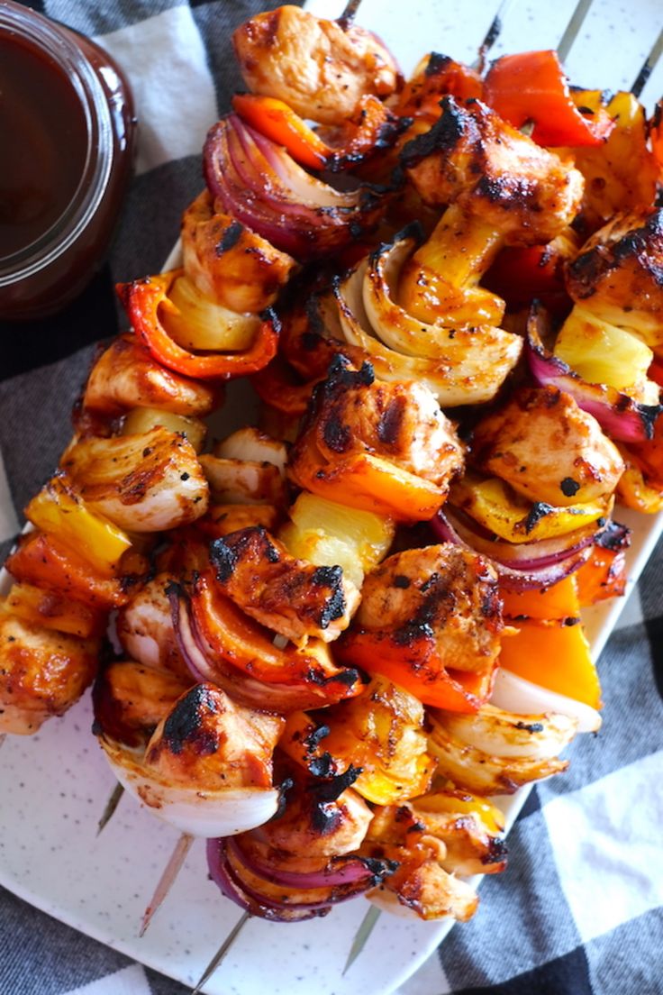 chicken and vegetable kabobs on skewers with dipping sauce