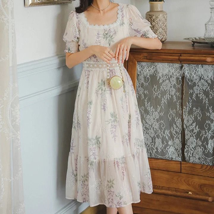 a woman standing next to a dresser in a room