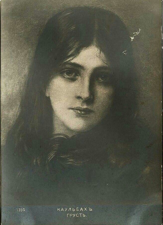 an old photo of a woman with long hair