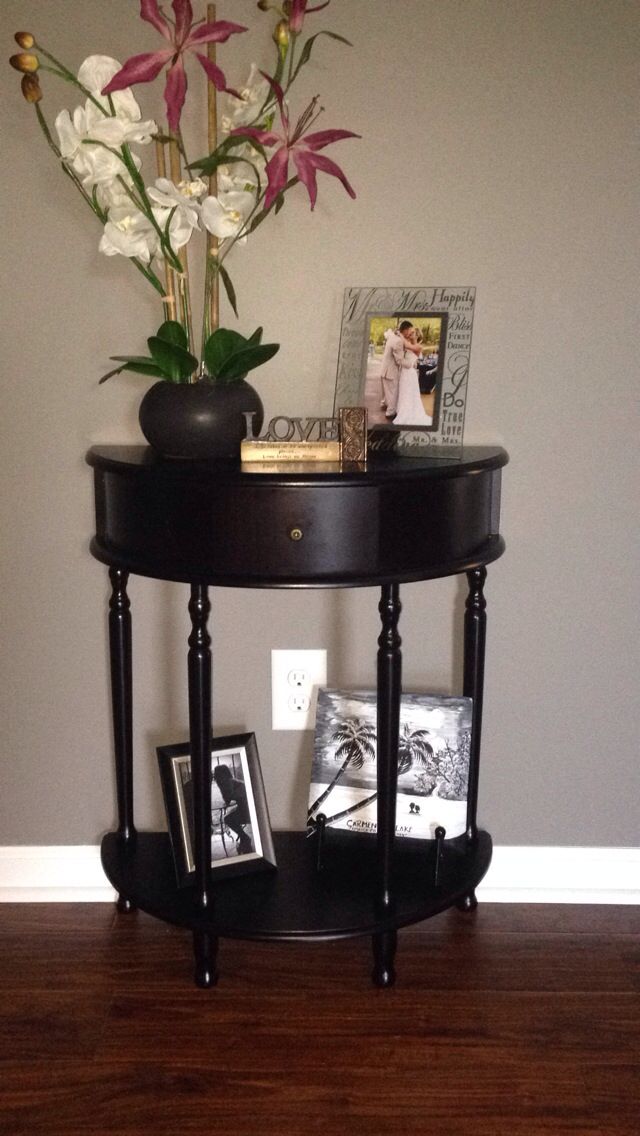 a black table with flowers and pictures on it