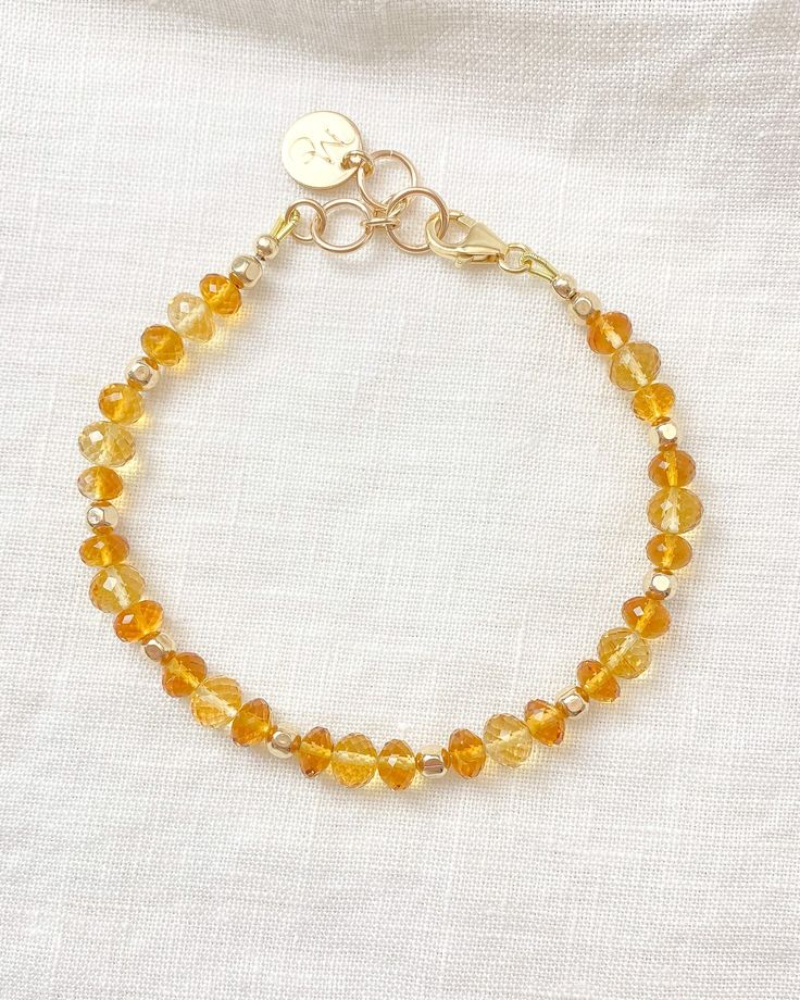 The enchanting combination of sunny yellow and rich amber-hued citrine creates this beautiful gemstone bracelet. This elegant beaded piece is finished with luminous 14k gold-filled components. November's birthstone is nothing less than captivating. Bracelet length: 7.25 inches plus 1-inch extender Materials: 4-6 mm citrine faceted beads, 14 k gold-filled components Elegant Gold Citrine Crystal Bracelet, Adjustable Citrine Yellow Gold Jewelry, Adjustable Yellow Gold Citrine Jewelry, 14k Gold-filled Gemstone Bracelets, 14k Gold Filled Gemstone Bracelets, Elegant Amber Beaded Bracelets With Natural Stones, Gold Gemstone Bracelet In 14k Gold Filled, Adjustable Gold Citrine Crystal Bracelet, Faceted Amber Round Bead Jewelry