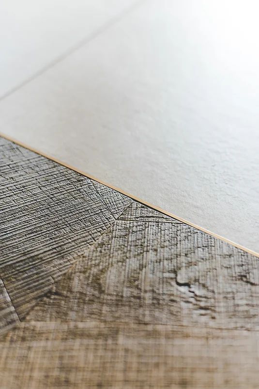 a close up view of a wood floor with white paint on the top and bottom