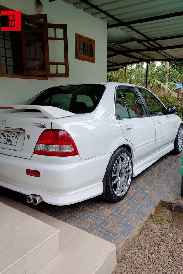 a white car parked in front of a house