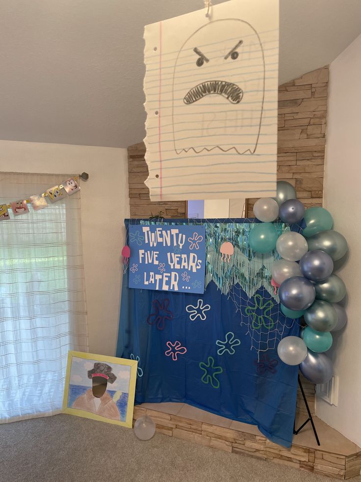 a bulletin board with balloons and pictures on it in a room decorated for the new year