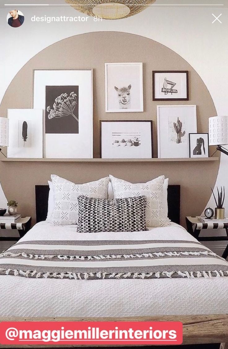 a bedroom with pictures on the wall above the bed