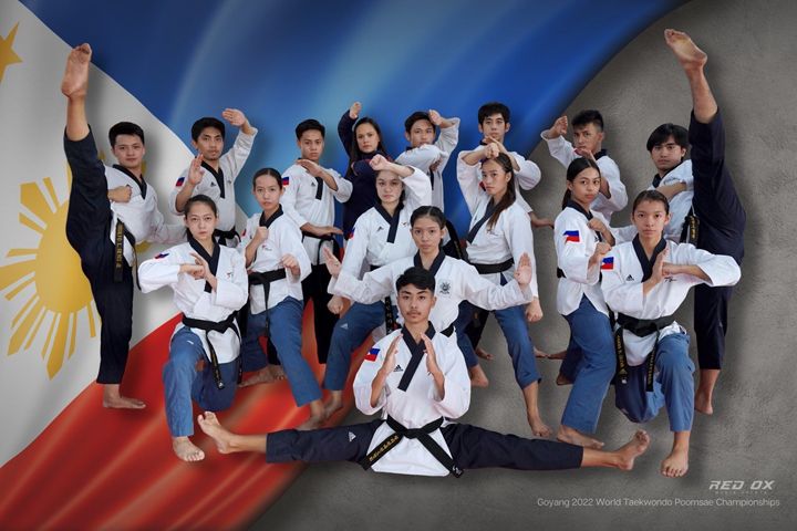 a group of people standing next to each other in front of a flag