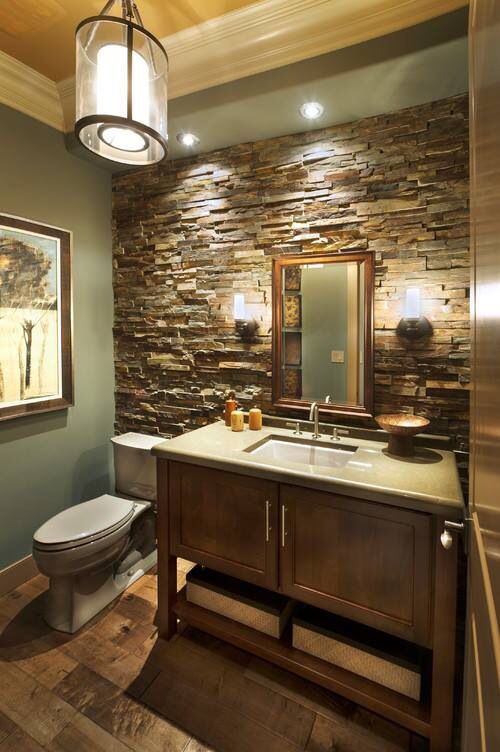 an image of a bathroom with stone walls and flooring on the bottom right hand corner