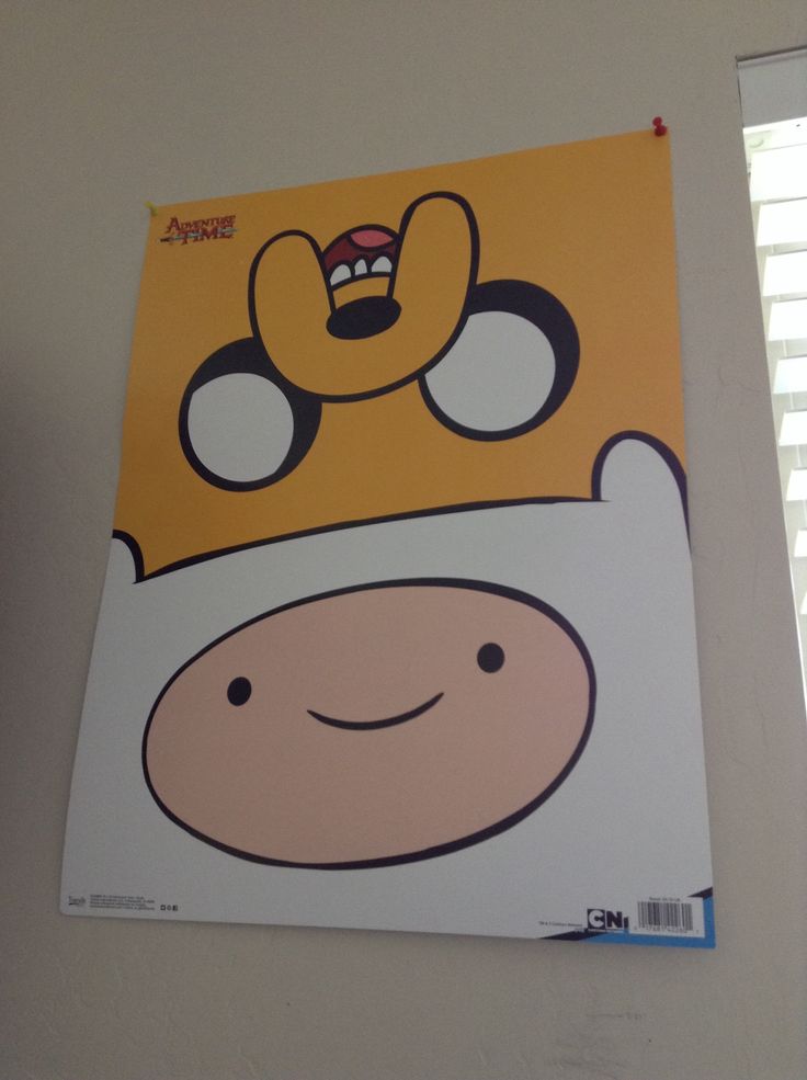 a yellow and white poster with a cartoon character on it's face hanging from the wall