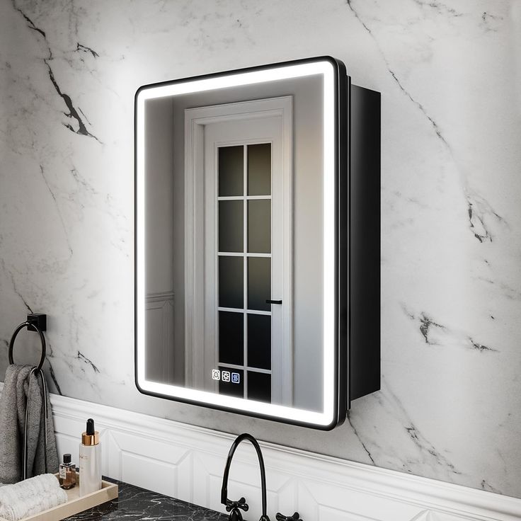 a bathroom sink with a lighted mirror above it