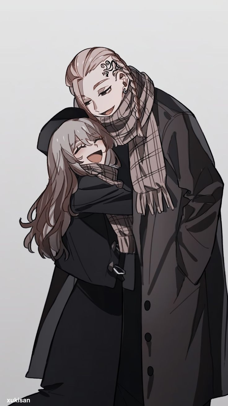 two people hugging each other in front of a gray background