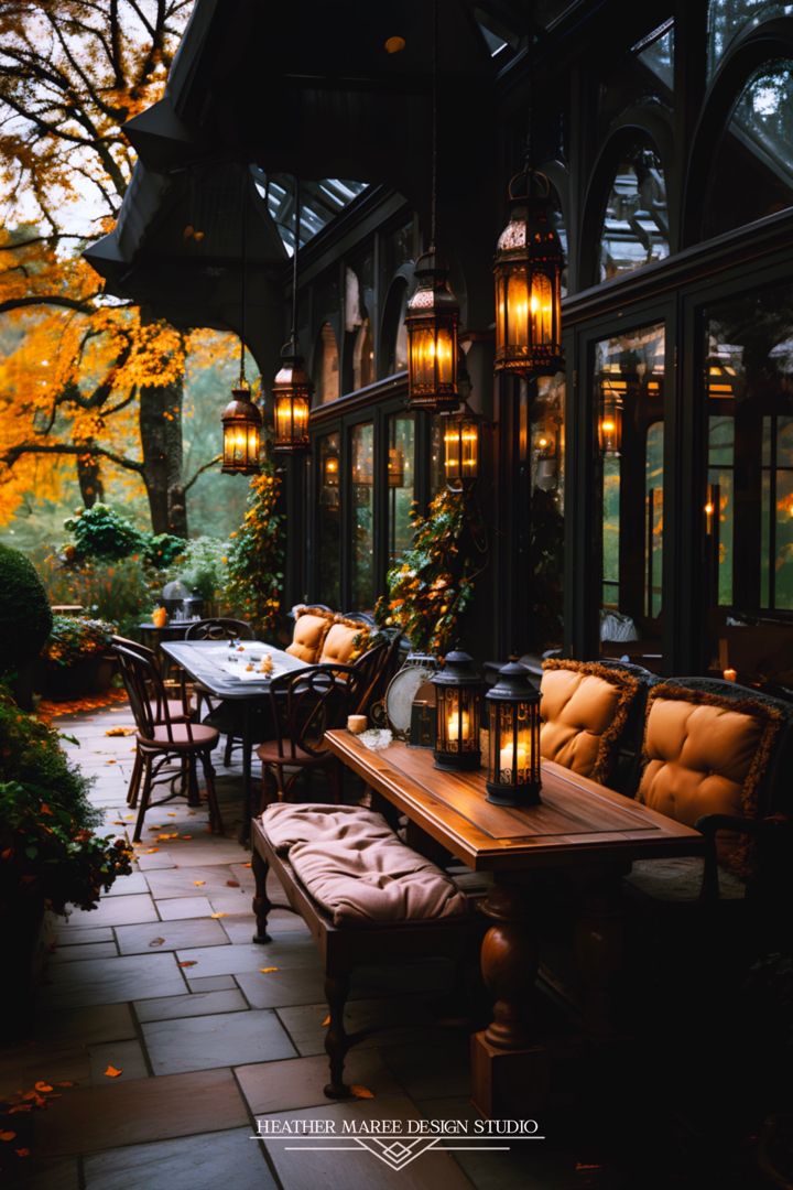 an outdoor dining area is lit up with lanterns