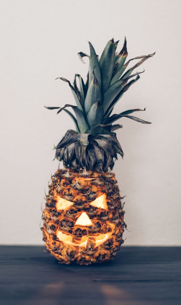 a pineapple with a carved jack o lantern on it