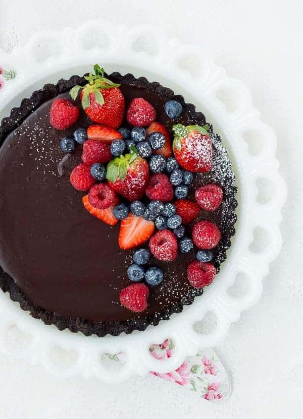 a chocolate cake topped with berries and strawberries