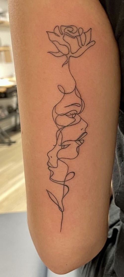 a woman's arm with a tattoo on it that has a rose in the middle