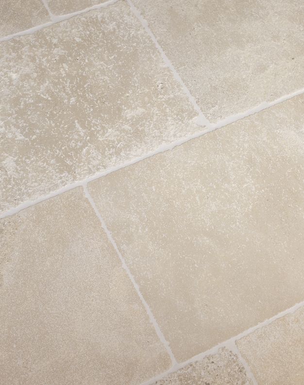 a white toilet sitting on top of a tiled floor