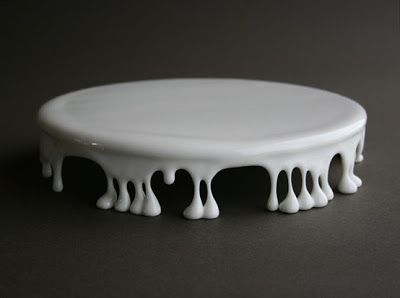 a white cake plate with dripping icing on it