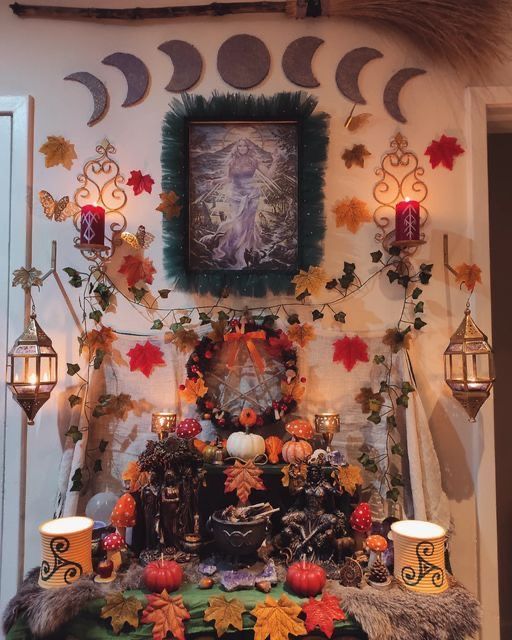 a table topped with candles and decorations in front of a wall