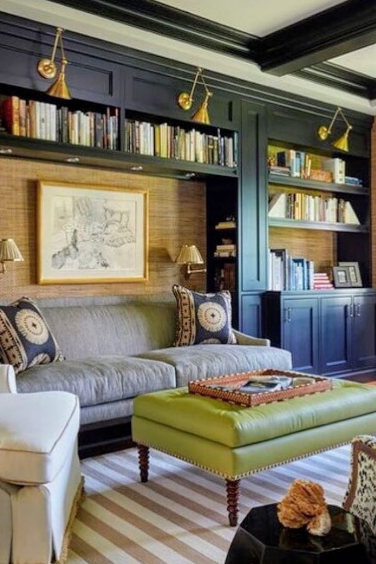 a living room filled with lots of furniture and bookshelves on top of shelves