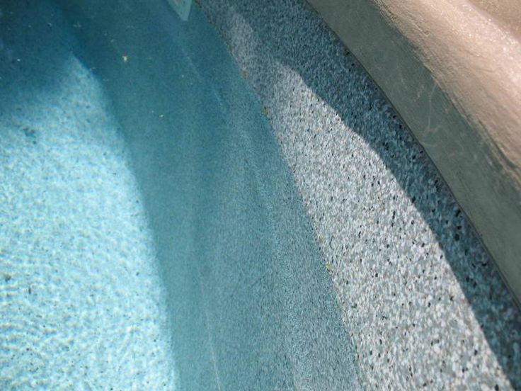 a pool with blue water is shown in this image from the bottom up, it appears to be reflecting light