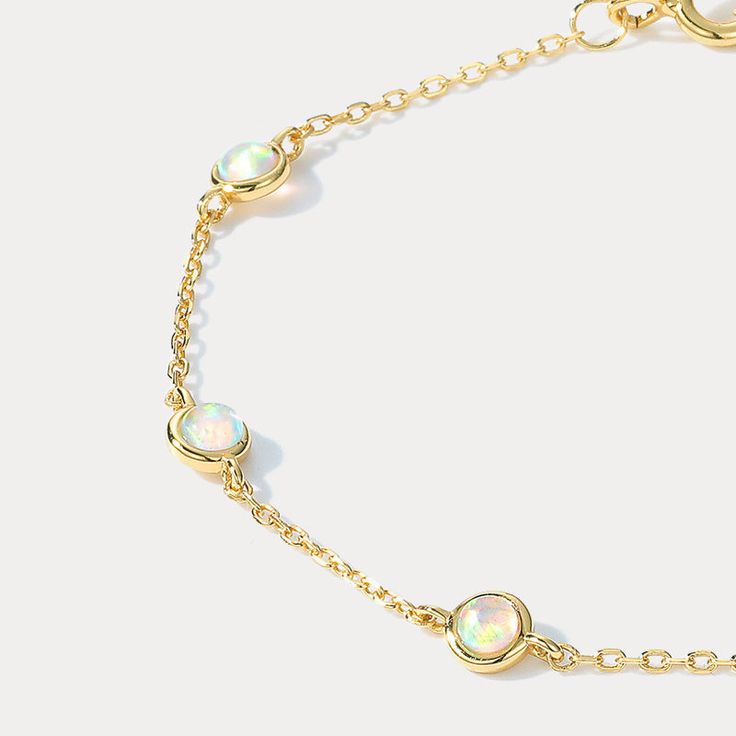 This exquisite Opal Round Diamond Bracelet is an ideal piece of jewelry to add to any collection. Delicately crafted with opal and diamonds, this stunning bracelet will add an upscale and luxurious feel to any wardrobe. Its perfect blend of precious stones give it a unique and timeless charm, making it a piece of jewelry you're sure to treasure for years to come. DETAILS Plating: 10K Gold Materials: 10K Gold  on   Silver, Simulated Opal Size:  Length:   7.09"(18cm) Silver Weight: 1.17g Stone Siz Tarnish Resistant Opal Jewelry For Gifts, Tarnish Resistant Opal Jewelry Gift, Tarnish-resistant Opal Jewelry Gift, Elegant Ethiopian Opal Jewelry, Opal Gemstone Bracelet Jewelry, Elegant Ethiopian Opal Gemstone Jewelry, Classic Opal Jewelry As A Gift, Classic Opal Jewelry For Gifts, Dainty Ethiopian Opal Jewelry