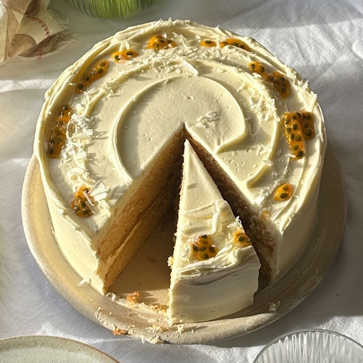 a white cake with one slice missing from it