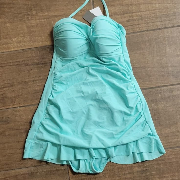 Kenneth Cole Reaction Mint Green One Piece Swimsuit With Ruffled Skirt. Ruched Sides. Built In Padded Bra. One Strap That Goes Around Neck. Lined. 82% Nylon 18% Elastane. Lining 100% Polyester. Size 4. New With Tags Fitted Solid Color Summer Swim Dress, Solid Fitted Tankini For Spring, Fitted Tankini For Spring, Fitted Solid Color Tankini For Spring, Fitted One-piece Swim Skirt For Spring, Solid Fitted Swim Skirt For Summer, Fitted Solid Swim Skirt For Summer, Fitted Solid Color Summer Swim Skirt, 2000s Dresses