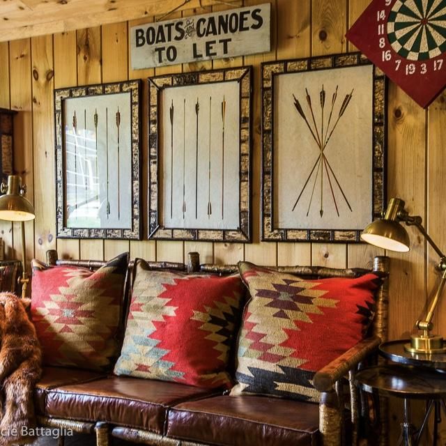 a living room filled with lots of furniture next to a wall mounted bullseye signs