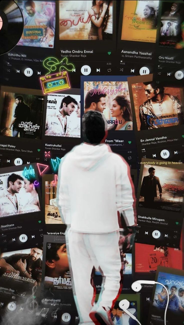 a man standing in front of a wall full of movie posters