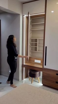 a woman standing in front of an open closet