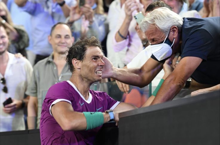 a tennis player is being greeted by fans