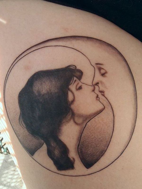 an image of a couple kissing in the moon tattoo on someone's back shoulder