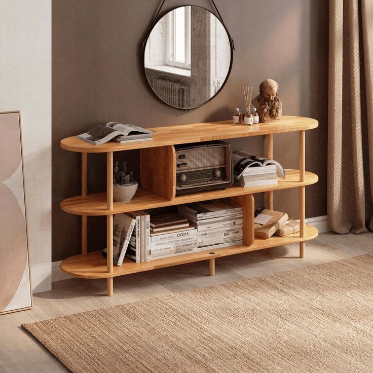 a living room with a round mirror on the wall next to a shelf filled with books